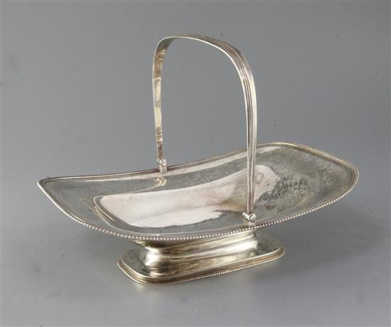 A George III silver swing handled cake basket, with gadrooned edge, London 1804, maker probably Timothy Renou, 27.5 oz.